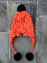 Load image into Gallery viewer, Handmade Aviator Hat | Orange with Black PomPoms
